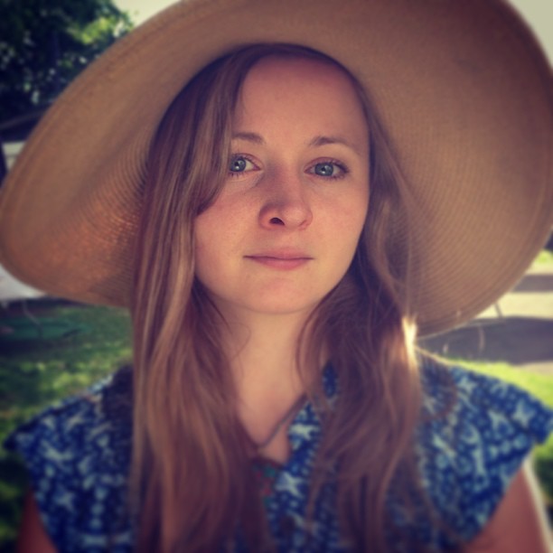 a woman wearing hat and a blue dress