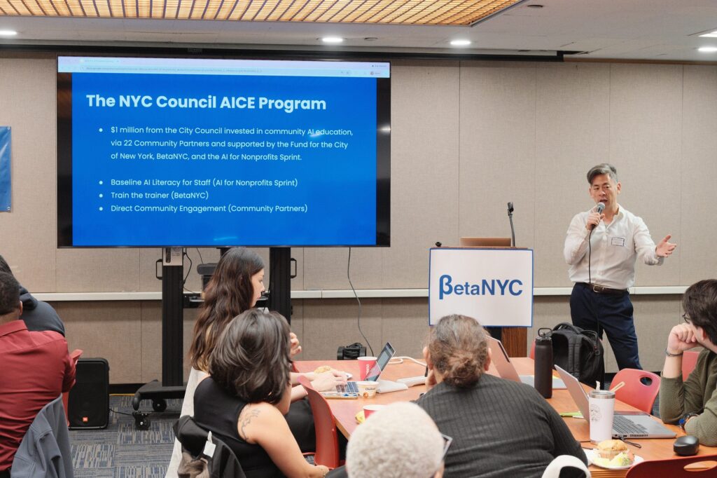 Steve Choi, presents a slide titled “The NYC Council AICE Program” to trainers seated at tables.