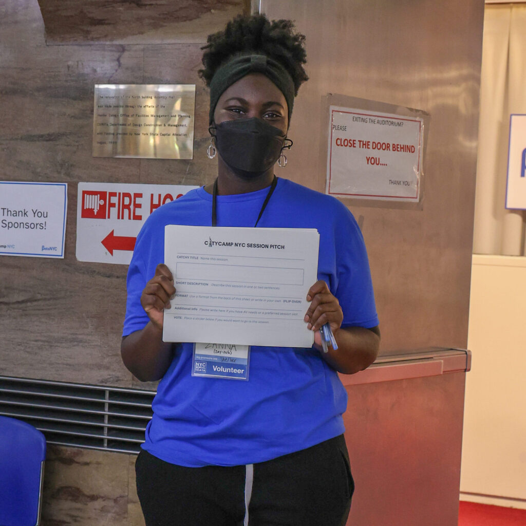 A volunteer holds up a blank CityCamp NYC session pitch form.