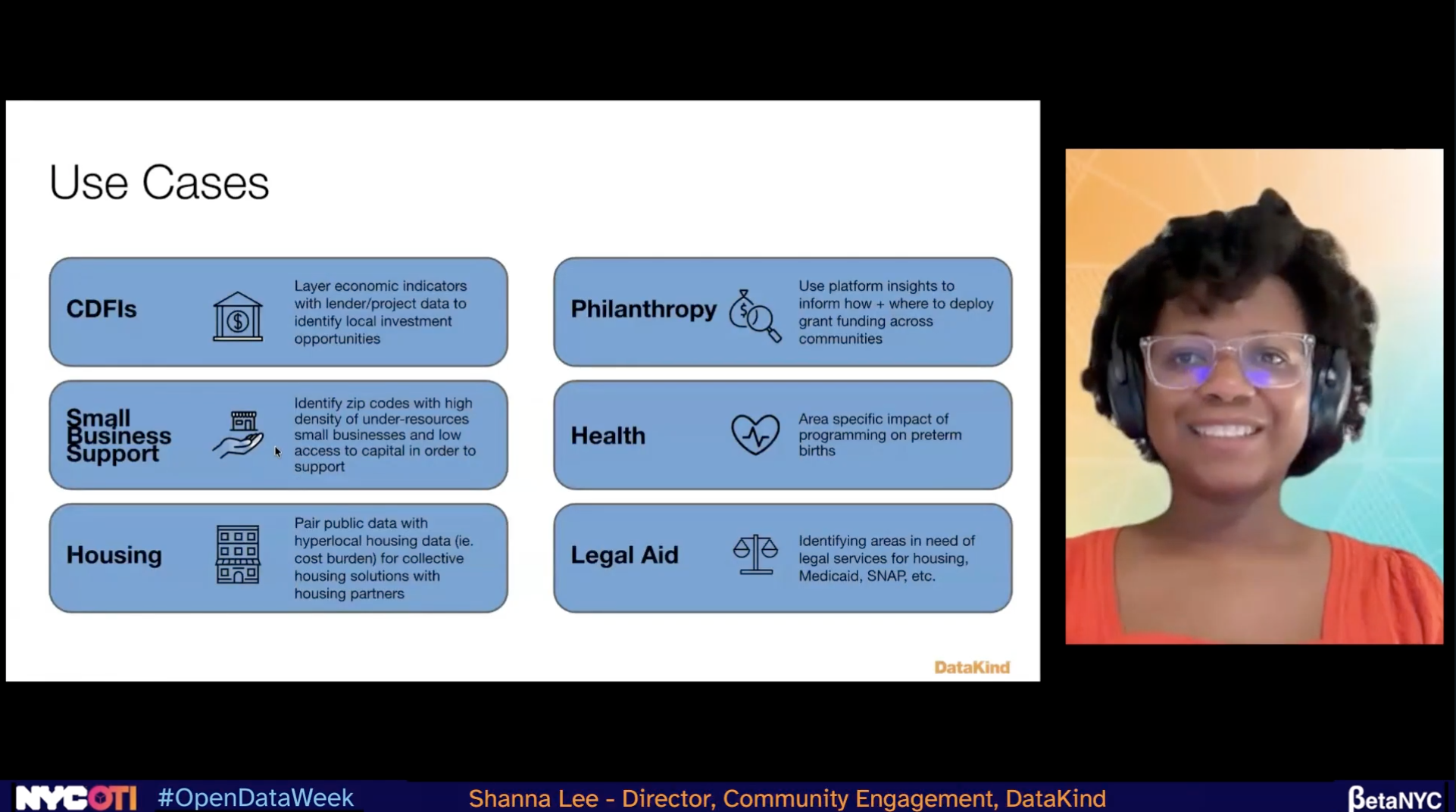 A horizontal split-screen from a NYC Open Data Week presentation on Zoom. On the right, a small video feed shows Shanna Lee, Director of Community Engagement at DataKind, a woman with short dark hair and glasses, wearing a red top and headphones, smiling.
On the left, a presentation slide titled "Use Cases" displays six categories of data application in rounded blue boxes.