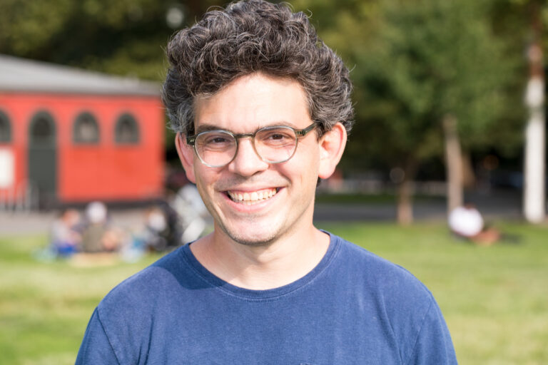 An image of Council Member Lincoln Restler wearing a dark blue top.