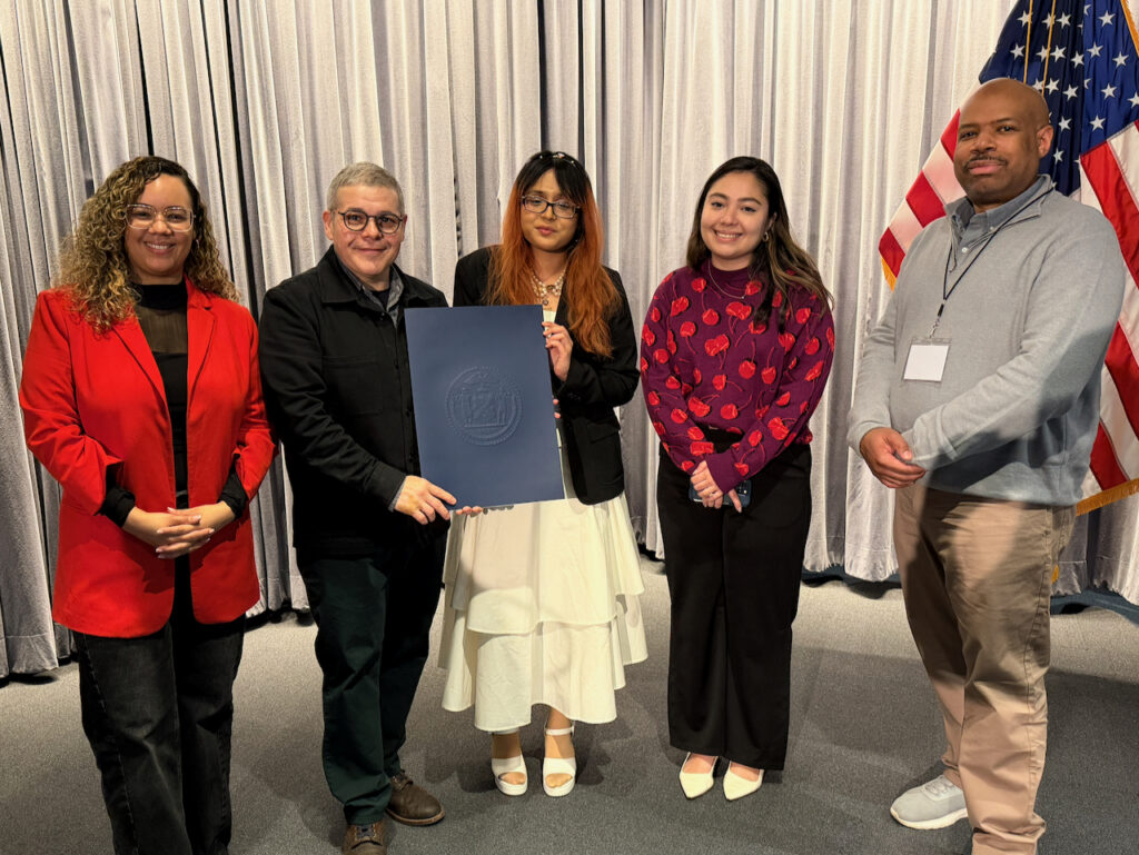 The School of Data opening session speakers stand alongside each other on stage.